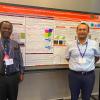 Two researchers stand beside a research poster on "Use of Artificial Intelligence and Computer Vision in Rural Transportation Resilience: Case Studies from Florida," which displays graphs, maps, and data visualizations.